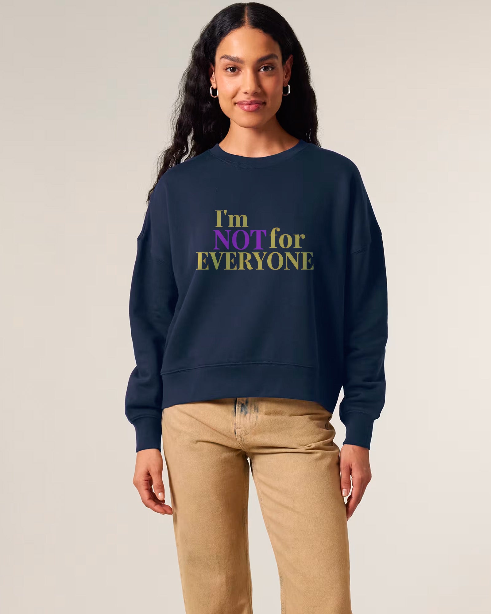 woman wearing a navy sweatshirt with 'I'm NOT for EVERYONE' text on a plain background