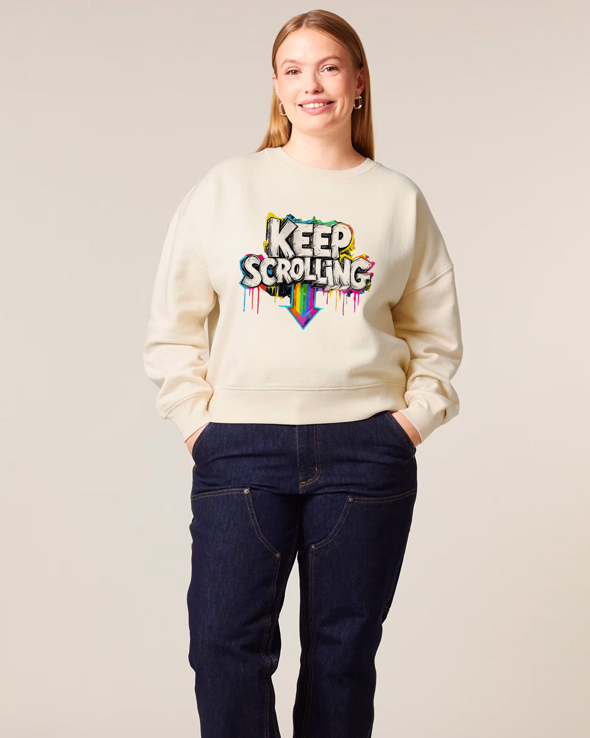 woman wearing a cream sweatshirt with 'Keep Scrolling' text design on a plain background