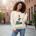 Woman wearing a cream sweatshirt with a colorful 'Just Dance' graphic on a city street.