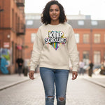 Woman wearing a beige sweatshirt with 'Keep Scrolling' text in an urban setting