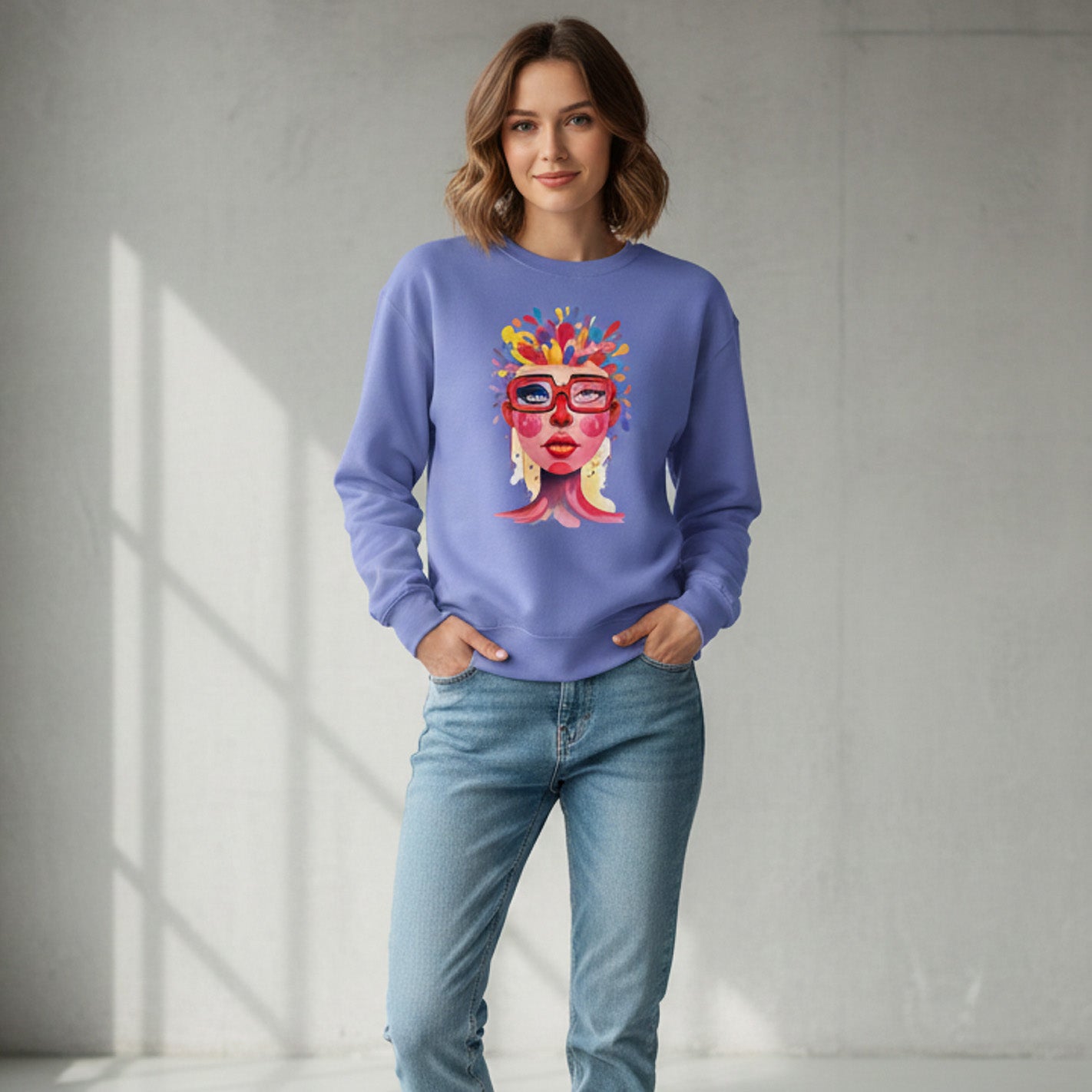 Woman wearing a purple sweatshirt with a colorful graphic design, standing in a well-lit room.