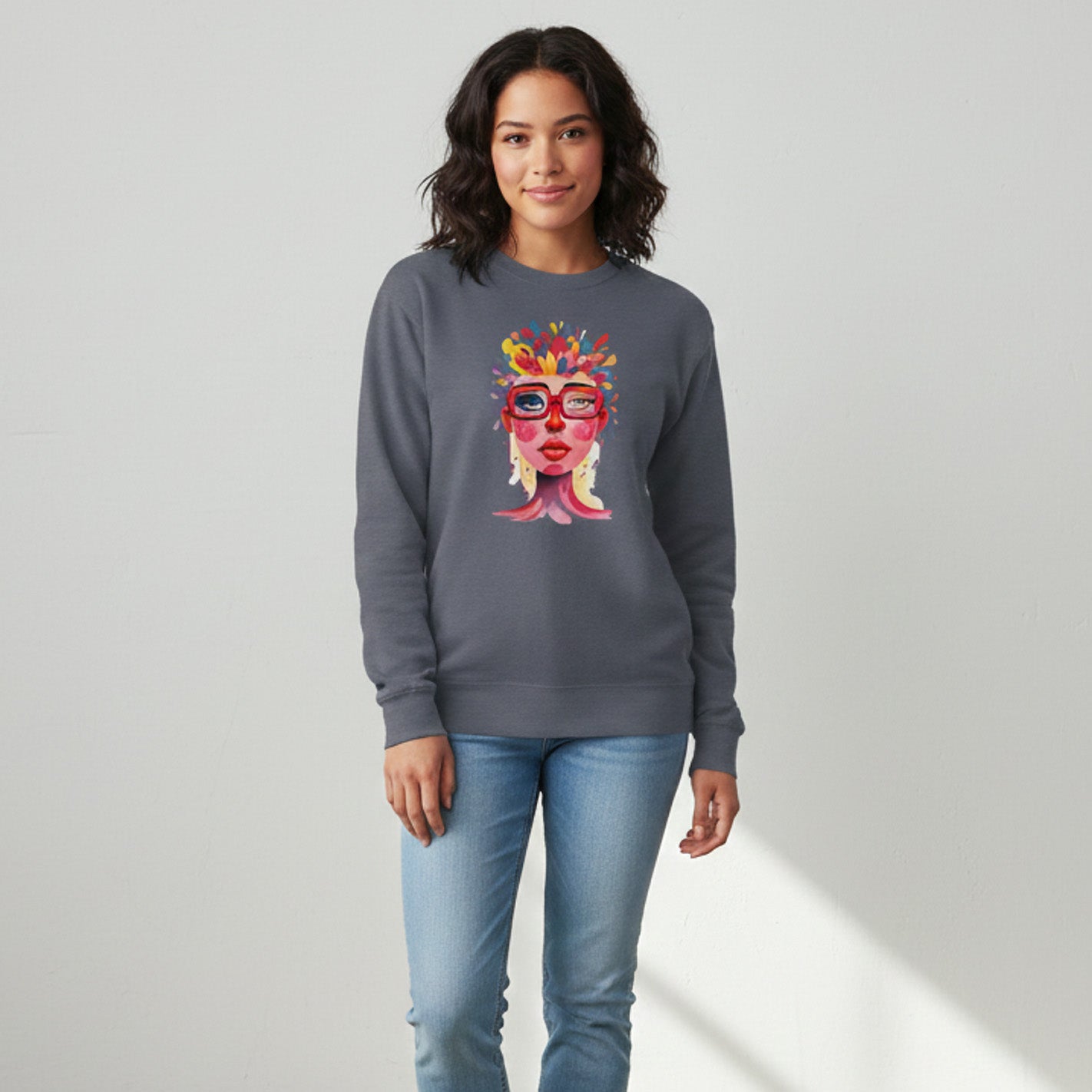 woman wearing a gray sweatshirt with a colorful graphic design on a plain background