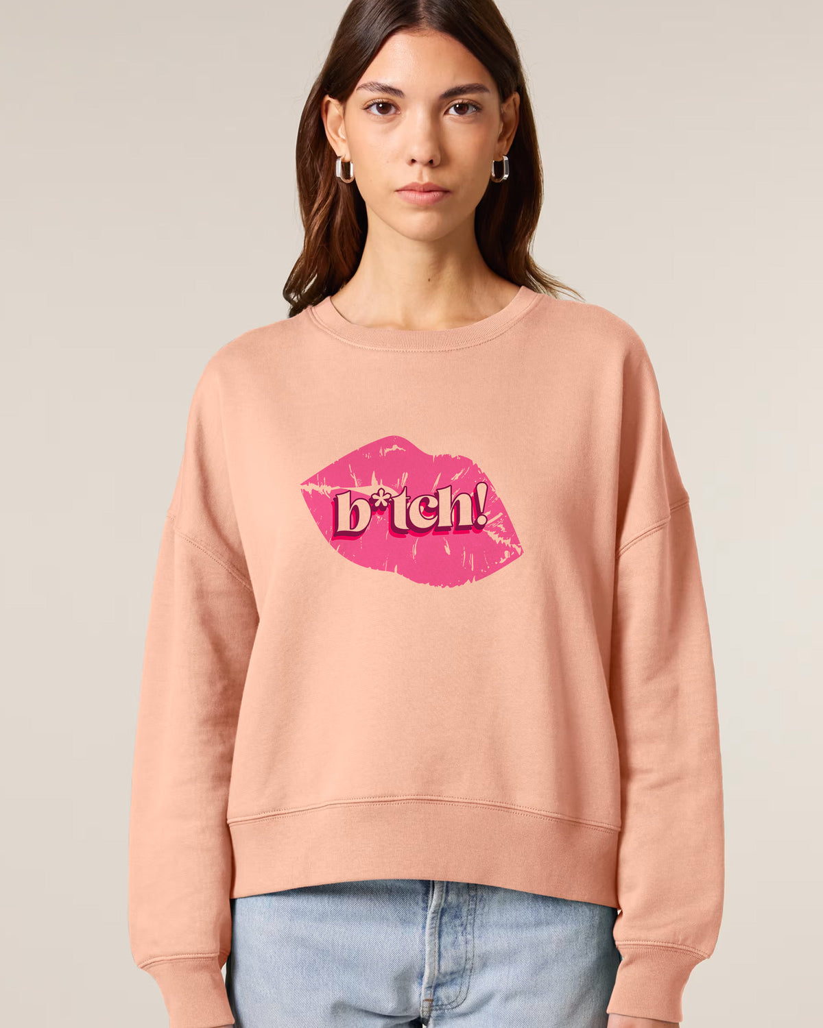 Woman wearing a Stanley/Stella sweatshirt with a graphic design on a plain background