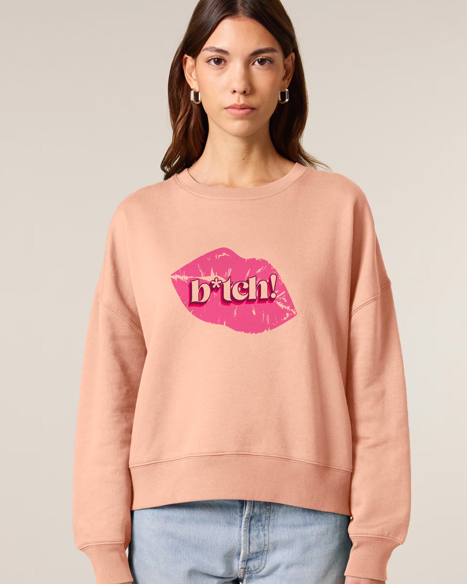 Woman wearing a Stanley/Stella sweatshirt with a graphic design on a plain background