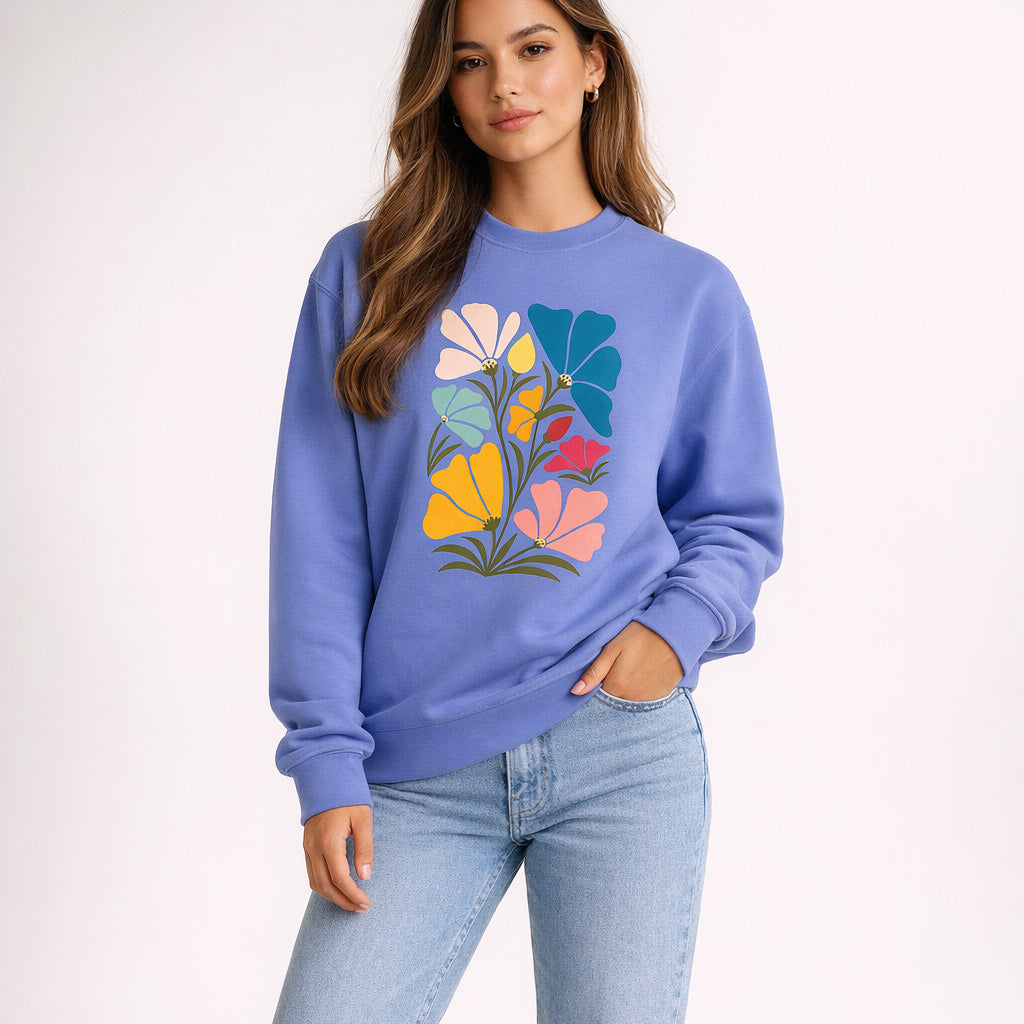 Woman wearing a purple sweatshirt with a colorful floral design on a white background
