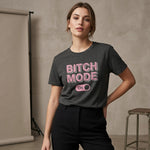 Woman wearing a dark gray t-shirt with 'BITCH MODE ON' in pink text against a neutral background.