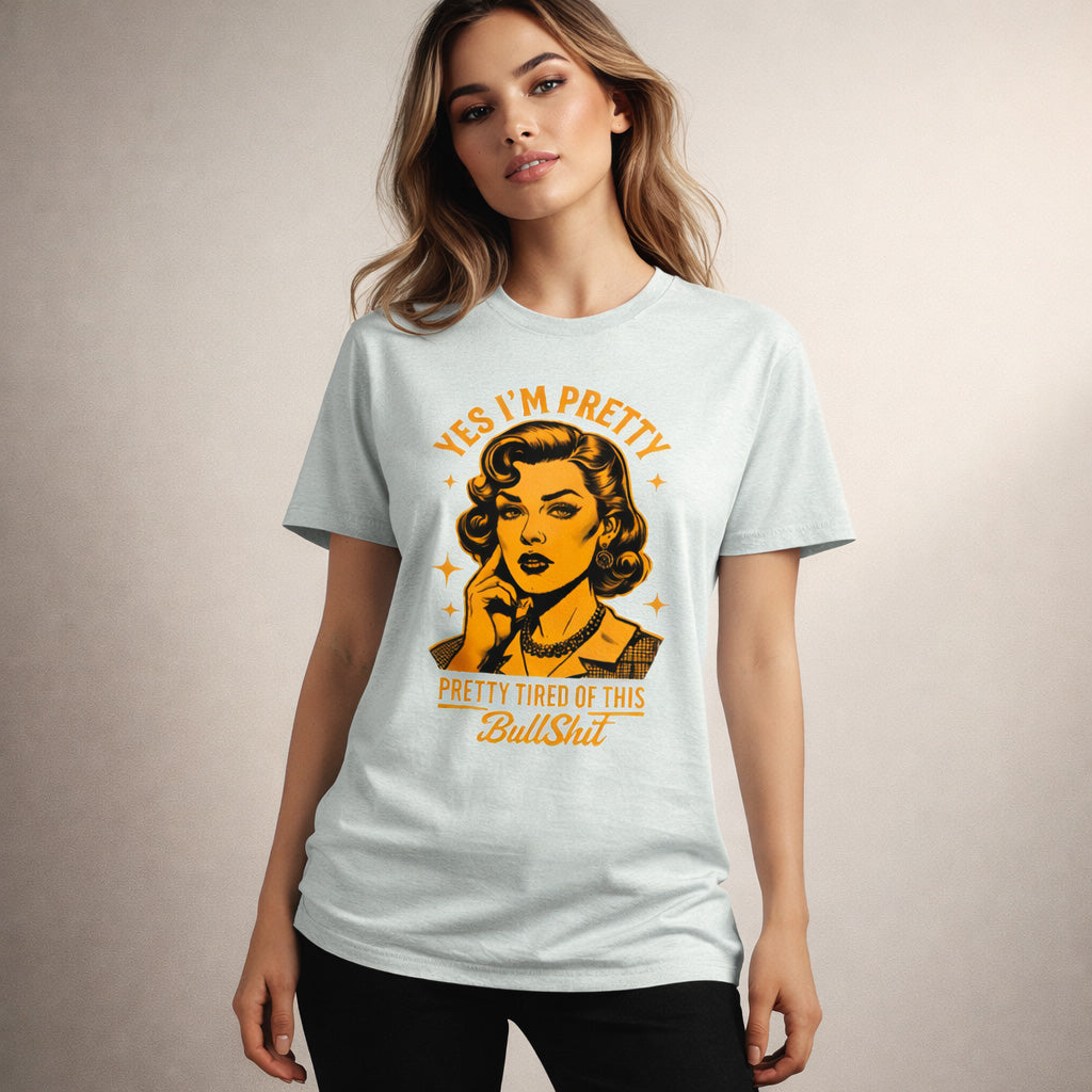 Woman wearing a light blue t-shirt with a graphic design and text.