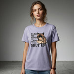 Woman wearing a purple t-shirt with a graphic of a cat and text on a gray background