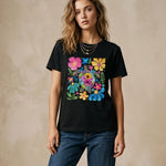 Woman wearing a black t-shirt with colorful floral design on a beige background