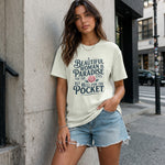 Woman wearing a t-shirt with a quote on a city street