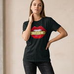 Woman wearing a black t-shirt with a graphic design of red lips and the word 'Bitch' on a beige background