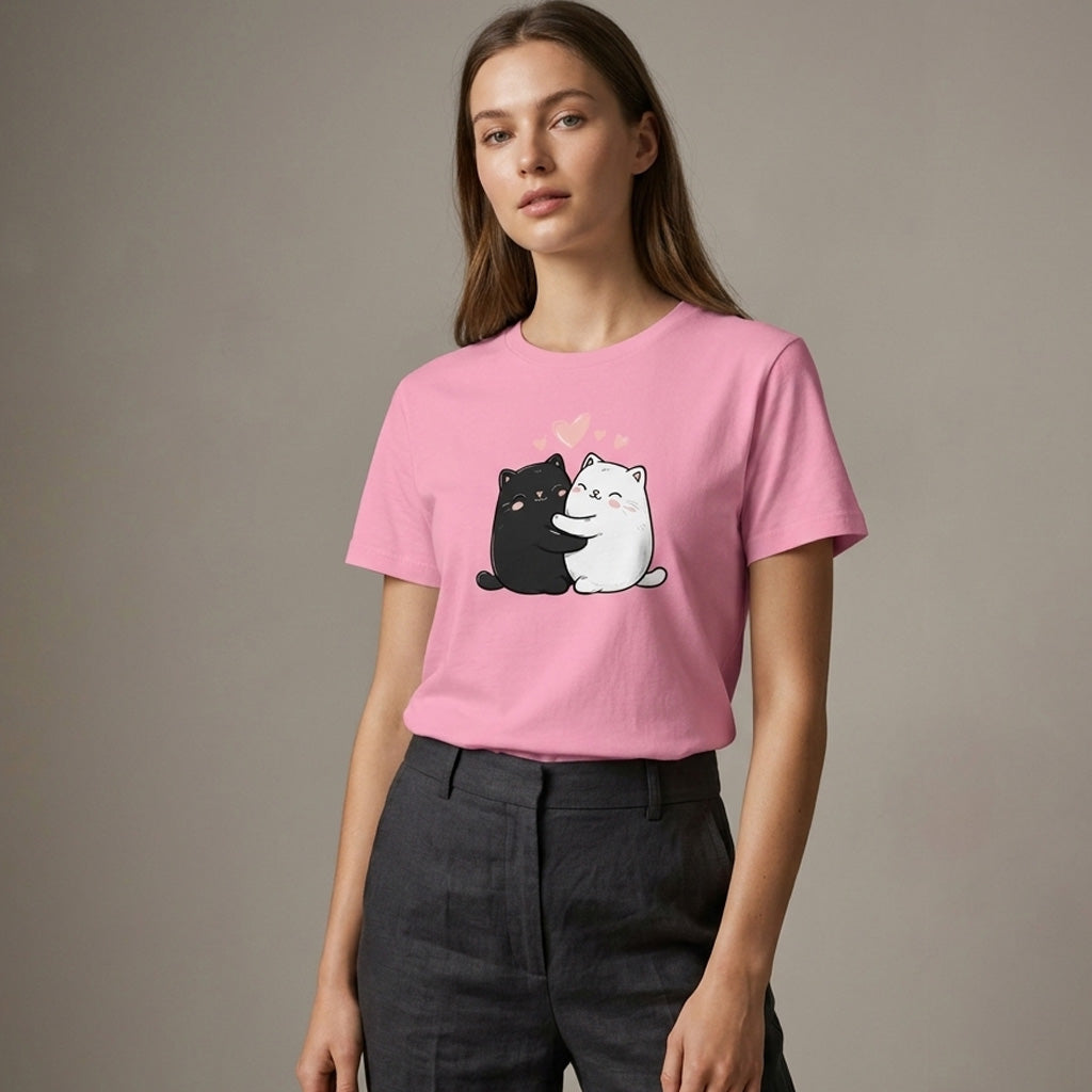 Woman wearing a pink t-shirt with cartoon cats on a plain background