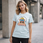Woman wearing a light blue t-shirt with a graphic design of a woman in sunglasses and text 'WHERE IS YOURS?'.
