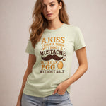 Woman wearing a light green t-shirt with humorous text design on a beige background