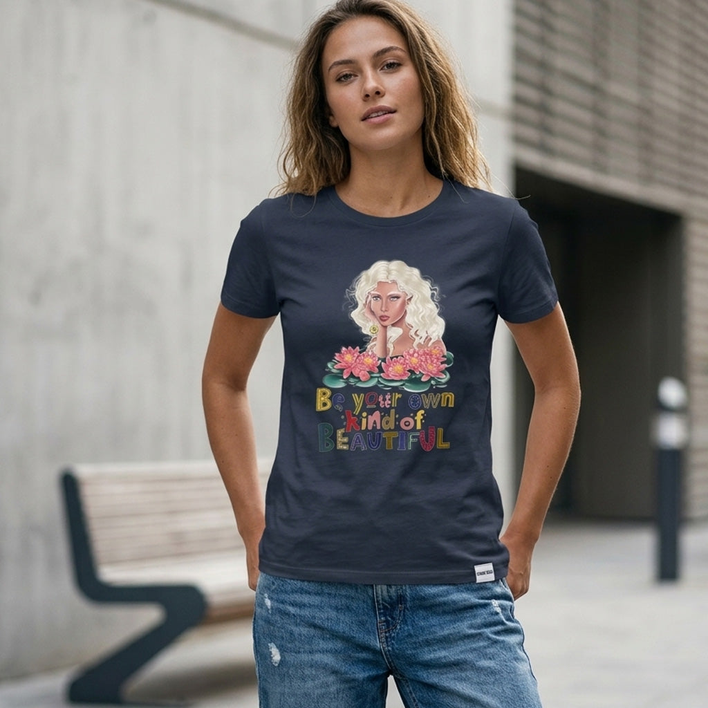 Woman wearing a navy blue t-shirt with a colorful graphic and text, standing outdoors.