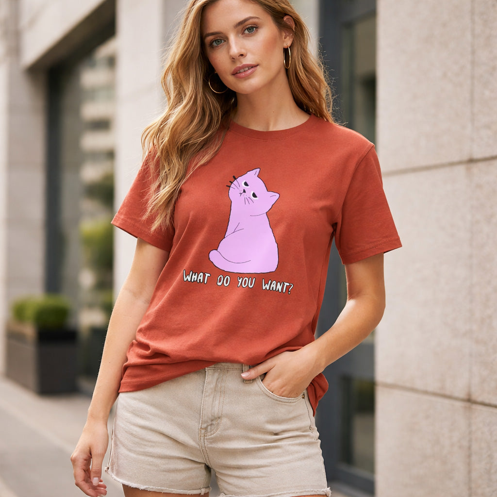 Woman wearing a red t-shirt with a purple cat graphic and text, standing outdoors.