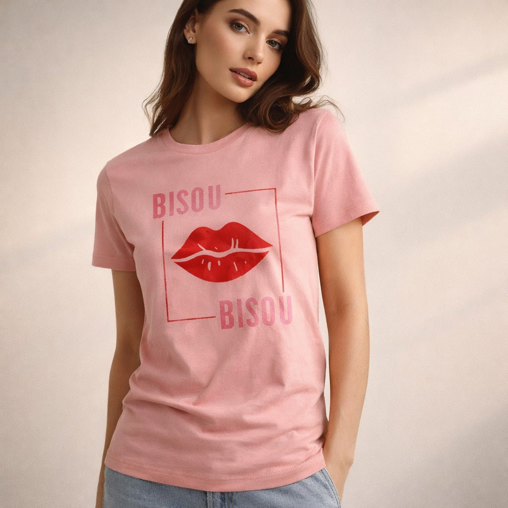 Woman wearing a pink t-shirt with red lip print and 'BISOU' text on a beige background
