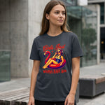 A woman stands outdoors wearing a dark T-shirt featuring a retro illustration of a woman lounging on a pink flamingo float, with the text "Girls Just Wanna Have Sun.