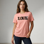 Woman wearing a pink t-shirt with 'LOVE' printed on it against a gray background