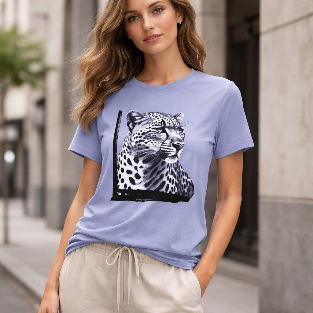 Woman wearing a light blue t-shirt with a leopard graphic on a city street.
